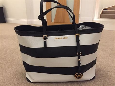 michael kors striped black and white bag|Michael Kors quilted black bag.